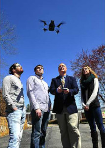 Dr. Payne (3rd from left) demonstrates a UNG quadcopter drone with student researchers.